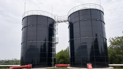 Food processing wastewater treatment tank project with twin black epoxy coated bolted steel tanks